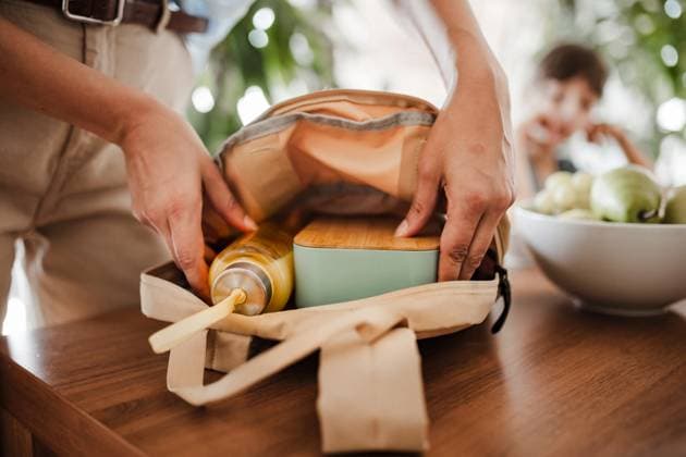 IMAGO Creative, Food, Trend, Meal Prep Mother packing school bag for kid. Putting bottle of juice, snacks for children into school bag. Snack, school lunch in a snack box for school. Mother packing school bag for kid. Putting bottle of juice, snacks for her children into school bag. Snack, school lunch in a snack box for school. model released Copyright: xx HHH WOMAN POWER DAY IN LIFE 2023 HHH 114