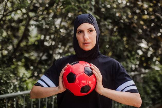 Beautiful female football player in hijab with ball in her hand. The woman plays soccer for relaxation. Concept of muslim woman in sport. Beautiful female football player in hijab with a ball in her hand. The woman plays soccer for relaxation. Concept of muslim woman in sport. model released Copyright: xx HHH WOMAN POWER DAY IN LIFE 2023 HHH 188