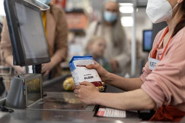 Checkout counter hands of the cashier scans groceries in supermarket. A checkout counter hands of the cashier scans groceries in supermarket. model released Copyright: xx I65A9407