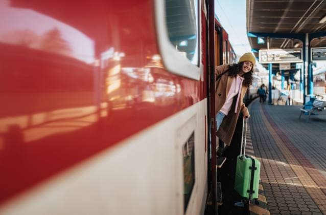 Happy young traveler woman with luggage getting off the train at train station platform A happy young traveler woman with luggage getting off the train at train station platform model released Copyright: xx IVANA MENTAL HEALTH STREET STYLE 2022-39