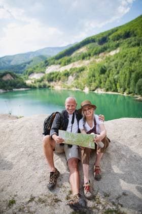 Happy senior couple on hiking trip on summer holiday, using map. A happy senior couple on hiking trip on summer holiday, using map. model released Copyright: xx Family_Lake_Holidays_2021_094