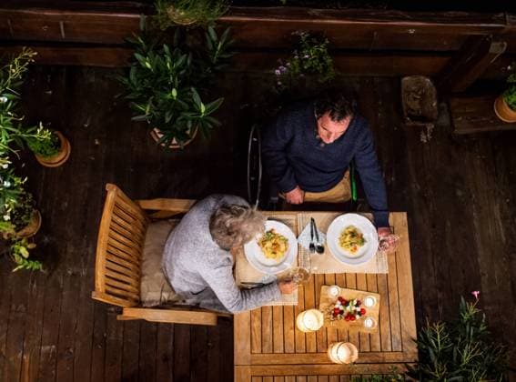 Top view of senior couple in wheelchair having dinner in the evening on terrace. Top view of senior couple in wheelchair having dinner in the evening on terrace, relaxing. model released Copyright: xx Gitka a Tonko Terrace 094
