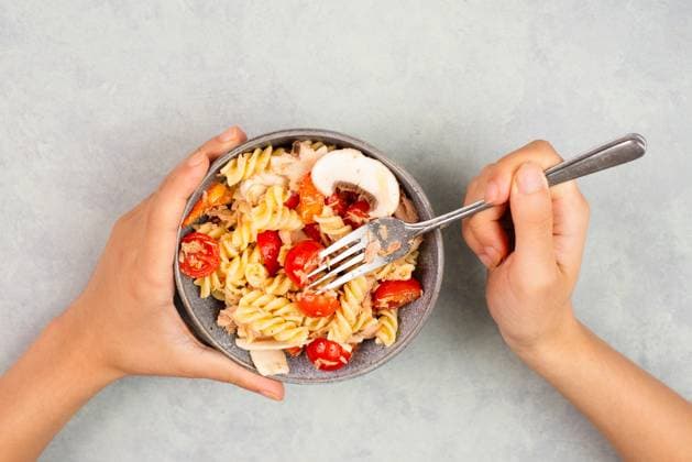 Eating a pasta salad with sliced mushroom, tomato, red pepper pieces and tuna, healthy food with vegetables, fresh organic nutrition Eating a pasta salad with sliced mushroom, tomato, red pepper pieces and tuna, healthy food with vegetables, fresh organic nutrition Copyright: xZoonar.com BeritxKesslerx 20817119