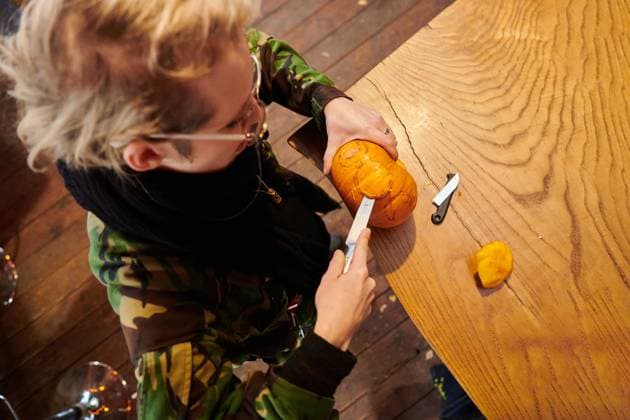 A modern blonde woman in military uniform is carving spooky pumpkins with a knife for Halloween night A modern blonde woman in military uniform is carving spooky pumpkins with a knife for Halloween night. ,model released, Symbolfoto Copyright: xZoonar.com BENISxARAPOVICx 20826809 ,model released, Symbolfoto ,property released