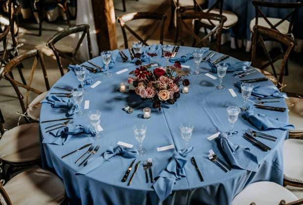 blue table cloth decorates wedding reception with flowers Scarborough, Maine, United States R_SSNF240120C-1300130-01