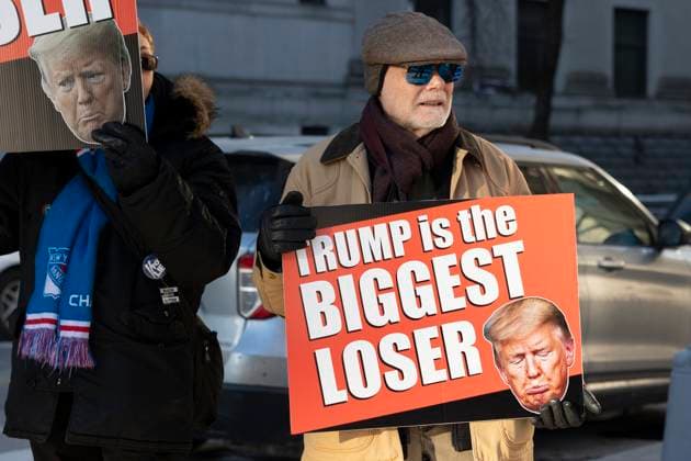 January 22, 2024, New York, New York, USA: Anti-Trump protesters with Rise & Resist hold signs outside of the U.S. District Courthouse as E. Jean Carroll and former President Donald Trump arrive for the defamation trial against Trump. .A person holds a sign with an image of Trump frowning that reads Ã¢â‚¬oeTrump is the biggest loser. New York USA - ZUMAr174 20240122_znp_r174_016 Copyright: xGinaxMxRandazzox