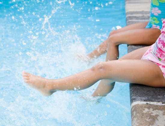 Hispanic girls splashing water in swimming pool Huntington Station, NY, 21.12.2023, model released, TTBB_BLD066963.jpg, 4-5 years, 6-7 years, active, barefoot, bathing suit, blurred motion, carefree, childhood, close up, color image, copy space, day, elementary age, energy, exhilaration, foot, friend, friendship, fun, girl, high angle view, horizontal, kicking, latin american and hispanic ethnicity, latina, leisure activity, low section, motion, only girls, outdoors, people, photography, playing, poolside, recreation, refreshing, side view, sister, sitting, splashing, summer, sunny, swimmer, swimming, swimming pool, together, two people, vacation, weekend activities, wetting, minority, minorities2, action, amusement, apparel, bathing costu Copyright: xJGI JamiexGrillx