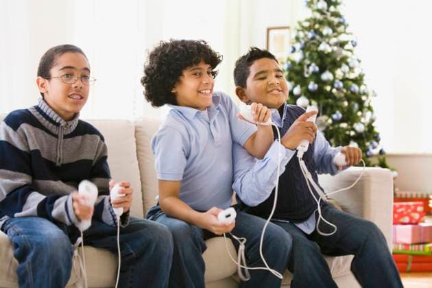 Boys playing video game at Christmas Studio New Jersey, 21.12.2023, model released, TTBB_BLD077650.jpg, 10-11 years, 12-13 years, african ethnicity, blurred motion, boy, brother, celebration, childhood, christmas, christmas tree, color image, competition, concentration, determination, domestic life, enjoying, entertainment, excitement, family, friend, fun, game, gaming, happy, holiday, horizontal, indoors, latin american and hispanic ethnicity, leisure activity, lifestyle, livingroom, mixed race person, motion, multi-ethnic group, people, photography, playing, pre-adolescent child, pushing, recreation, remote control, sitting, skill, smiling, technology, three people, three quarter length, video game, multicultural, multiculturalism, mino Copyright: xJRxCarvey StreetflyxStudiox