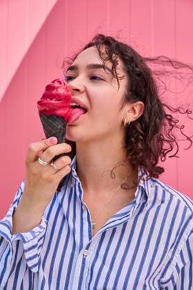 Creative Highlights Symbolbilder Happy woman licking ice cream in front of pink wall model released, Symbolfoto, SECF00012