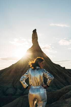 Creative Highlights Symbolbilder Woman with hand on hip standing in front of back lit Castildetierra at sunset model released, Symbolfoto, DAMF01229