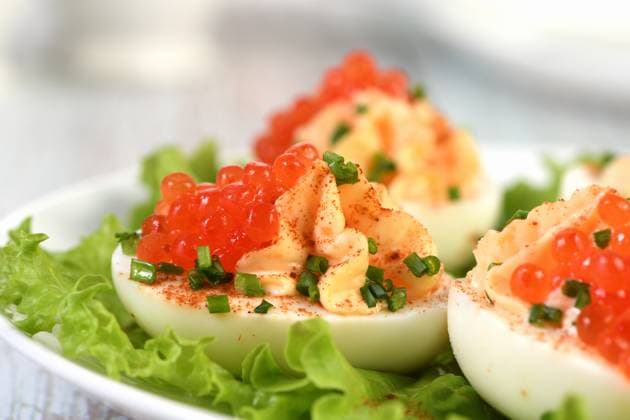 Stuffed eggs with salmon caviar Stuffed eggs with salmon caviar are a popular appetizer for any occasion. Elegantly decorated and expertly seasoned, they will always be a beautiful appetizer at a party. Copyright: xZoonar.com MarynaxVoronovax 20902817