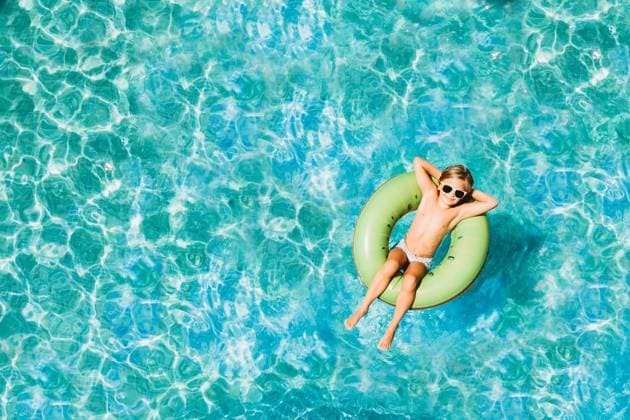 Young child floating in pool with floats photo from above with drone Spain, Andalusia, Benalmádena CR_TANI2401238D-1340207-01 ,model released, Symbolfoto