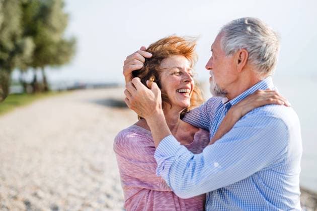 Senior couple on a holiday on a walk by the lake, hugging. Front view of senior couple on a holiday on a walk by the lake, hugging. model released Copyright: xx Wind_Energy_Neusiedler_2019_312