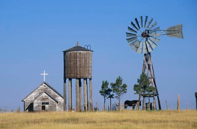 Windmill and abandoned prairie church, WY Windmill and abandoned prairie church, WY <br>Model Release: No<br>Property Release: No EDITORIAL USE ONLY Copyright: xx VOA23-037 JoexSohmx voaphotos017199