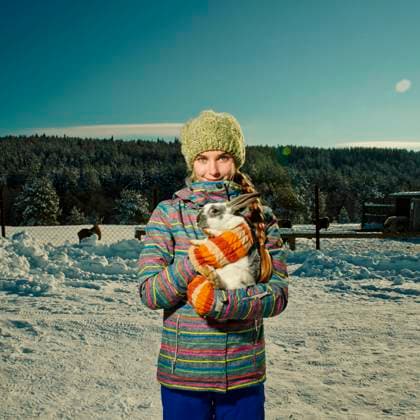 Caucasian girl hugging rabbit in snowy field Nizniy Tagil, Sverdlovsk, Russia, 21.12.2023, model released, TTBB_BLD159936.jpg, 14-15 years, affection, animals, blue sky, bonding, braid, caucasian, coat, cold, color image, copy space, countryside, day, enjoying, farm, field, focus on foreground, front view, happy, hat, holding, hugging, lens flare, long hair, looking at camera, mitten, nature, one animal, one person, outdoors, people, pet, photography, portrait, posing, rabbit, smiling, snow, snow-covered, square image, standing, teenage girl, teenage girls, teenager, three quarter length, together, travel, travel destinations, vacations, warm clothing, winter, accessory, affectionate, animal, apparel, appreciating, bunny, cap, cheerful, ch Copyright: xVladimirxSerovx