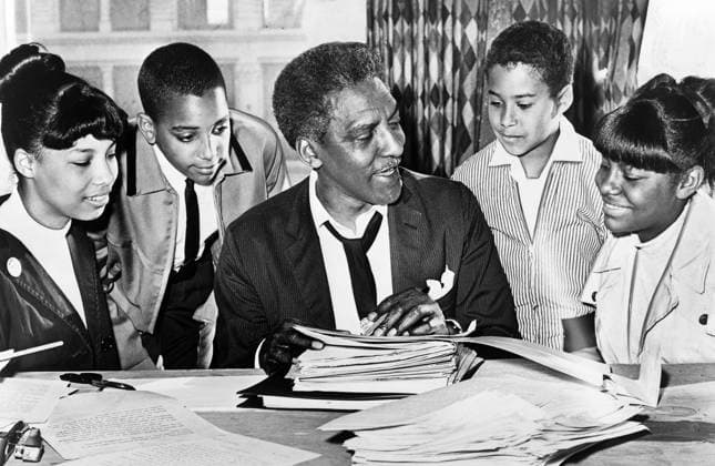 Bayard Rustin (center) speaking with (left to right) Carolyn Carter, Cecil Carter, Kurt Levister, and Kathy Ross, before demonstration, Ed Ford, New York World-Telegram and the Sun Newspaper Photograph Collection, 1964  Copyright: xCircaxImagesx ghi-circa12285
