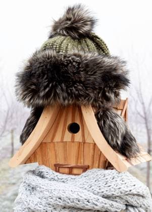 Handmade birdhouse in winter, wearing a knitted cap and scarf. cold snowy weather background. heatin Handmade birdhouse in winter, wearing a knitted cap and scarf. cold snowy weather background. heating system, house insulation concept Copyright: xZoonar.com Smilla72!x 21045192