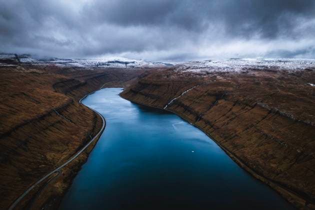 Aerial view of fjord and snow dusted mountains, Faroe Islands Tórshavn, Streymoy, Faroe Islands CR_SSNF240118-1314118-01