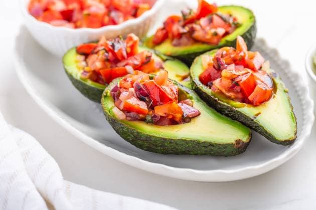 Avocados filled with bruschetta and balsamic vinaigrette - vegan appetizers Avocados filled with bruschetta and balsamic vinaigrette - vegan appetizers Copyright: xZoonar.com IngridxBalabanovax 21106609