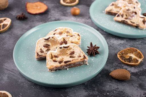 Christstollen, traditonal christmas cake with nuts, raisons, marzipan on a textured background, empty space for text 2773281 RECORD DATE NOT STATED