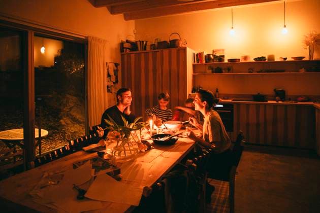 Happy family enjoying candle night dinner while sitting at dining table in home Sweden, Stockholm, model released, property released Copyright: xMaskotx , MA106642 MA106642
