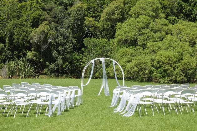 Wedding ceremony on green lawn in the garden White wedding arch outdoors. Beautiful wedding set up. Wedding ceremony on green lawn in the garden. Avarua Cook Islands EDITORIAL USE ONLY Copyright: xx RafaelxBen-Arix cewitness039064