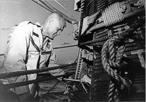 Glenn Inspects Friendship 7 Astronaut John H. Glenn, Jr. checks the Friendship 7 spacecraft after completing three orbits around the Earth, traveling at 17,500 miles per hour on February 20, 1962. The destroyer Noa picked-up Glenn and the spacecraft 21 minutes after landing near Grand Turk Island. A capsule technician inside the spacecraft checks the interior for any damage. Credit: NASA via CNP At Sea Aboard the USS NOA United States of America EDITORIAL USE ONLY Copyright: xx 62-MA6-137 MA6-41 NASAx cnpphotos032476