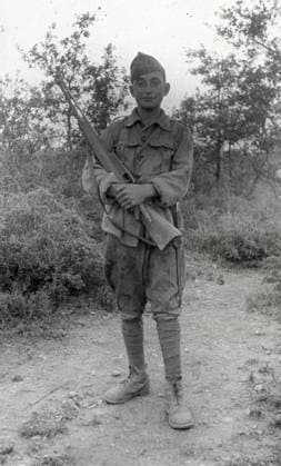 Full-length portrait of a young Spaniard in the service of an Italian officer during the Spanish civil war, on July 18, 1938. The boy, in uniform, is holding his rifle in a position af at ease (b w photo) 1250025 Full-length portrait of a young Spaniard in the service of an Italian officer during the Spanish civil war, on July 18, 1938. The boy, in uniform, is holding his rifle in a position af at ease (b w photo) by Unknown photographer, (20th century); (add.info.: Unidentified Author Spain); Fratelli Alinari Museum Collections, Florence, Italy. Copyright: xFratellixAlinarixMuseumxCollections,xFlorence,xItalyx xBridgemanxImagesx 1250025