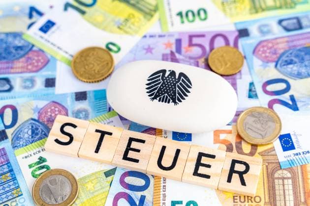 Augsburg, Bavaria, Germany - February 7, 2024: Euro banknotes with the logo of the German federal eagle and Bundestag and the inscription: Steuer *** Euro Geldscheine mit dem Logo des deutschen Bundesadler und Bundestag und dem Schriftzug: Steuer