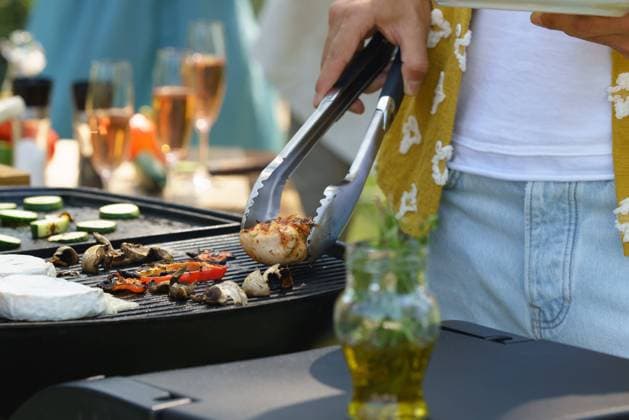 Meat and vegetables grilling on outdoor grill. Outdoor grill or BBQ party in the garden. Meat and vegetables grilling on an outdoor grill. Outdoor grill or BBQ party in the garden. model released
