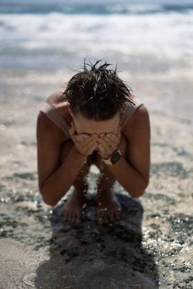 Creative Highlights Symbolbilder Young woman bathes in the ocean washes face salt water, beach holiday Lembongan, Bali, Indonesia CR_YUKI240208C-1331411-01 ,model released, Symbolfoto