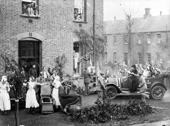 Announcing the Armistice at the American Hospital in Dartford, 1918 (b w photo) 4072731 Announcing the Armistice at the American Hospital in Dartford, 1918 (b w photo); Private Collection; (add.info.: A great crowd gathered about the Red Cross car which announced the signing of the armistice to the Americans at the big base hospital at Darford near London. As the car reached the larger ward buildings there was pandemonium. The man in the wheel chair forgets his aillments, and to the horror of his nurse, jumps up almost too fast for the camera, and rushed over to get one of the little news sheets which the Red Cross messenger is distributing ). Copyright: xBridgemanxImagesx 4072731