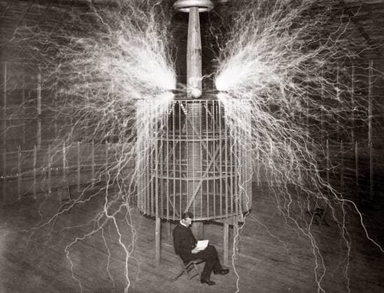 Nikola Tesla sitting in his Colorado Springs laboratory with his Magnifying Transmitter?, 1899 (multiple exposure) XEE4152964 Nikola Tesla sitting in his Colorado Springs laboratory with his Magnifying Transmitter?, 1899 (multiple exposure) by Unknown photographer, (19th century); Private Collection; (add.info.: Nikoka Tesla); Stefano Bianchetti. Copyright: xStefanoxBianchettix xBridgemanxImagesx 4152964