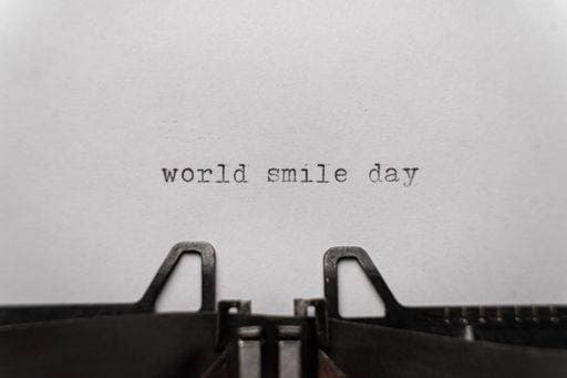 world smile day typed words on a typewriter vintage 3035292