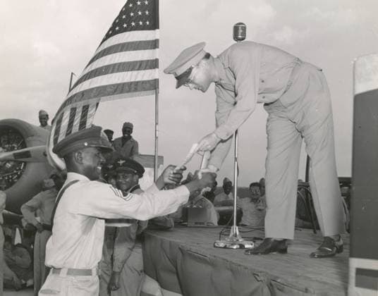Sgt. James O.B. Moseley of the 313th Army Air Force Band receiving congratulations, Tuskegee Army Air Field, Alabama, 1941 (b w photo) 7214971 Sgt. James O.B. Moseley of the 313th Army Air Force Band receiving congratulations, Tuskegee Army Air Field, Alabama, 1941 (b w photo); Private Collection; (add.info.: Receiving congratulations for the winning entry in a contest held at the post, with an outstanding marching song.). Copyright: xBridgemanxImagesx 7214971