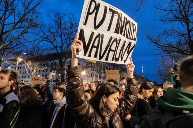 February 16, 2024, Berlin, Germany: A protester holds a placard saying, Putin killed Navalny at a makeshift memorial and protest in front of the Russian embassy in Berlin following the death of Russian opposition leader Alexey Navalny. Berlin Germany - ZUMAs197 20240216_aaa_s197_450 Copyright: xNicholasxMullerx