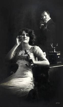 Woman Holding Telephone Receiver with Man Talking on Telephone in Background, French Postcard  Copyright: xABxArchivex jtv005100