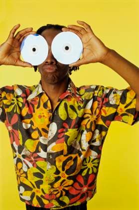 Portrait of a man holding two CDs in front of his eyes  Copyright: xx 1295R-580