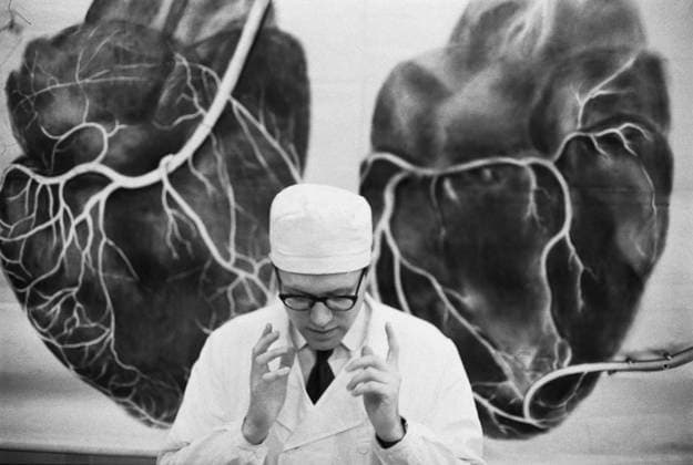 December, 1970. Leningrad, USSR. Surgeon Yevgeny Kolesov, son of professor of the 1st Leningrad Medical Institute, cardiac surgeon Vasily Kolesov is pictured against the background of two hearts in the clinic of the faculty surgery of the 1st Leningrad Medical Institute. The exact date of the photograph is unknown. Yuri Belinsky TASS  32436081