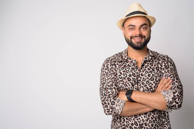 Portrait of happy young bearded Indian man smiling with arms crossed Studio shot of young handsome bearded Indian man against white background ,model released, Symbolfoto Copyright: xZoonar.com TonixRantalax 14445019 ,model released, Symbolfoto ,property released