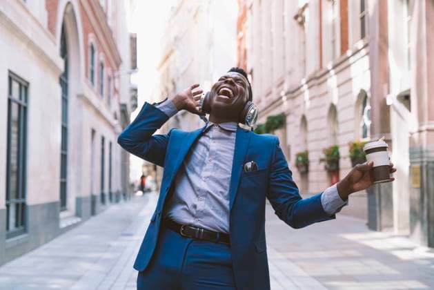 Creative Highlights Symbolbilder Cheerful mature businessman wearing wireless headphones holding coffee cup and enjoying on street model released, Symbolfoto, OIPF03784