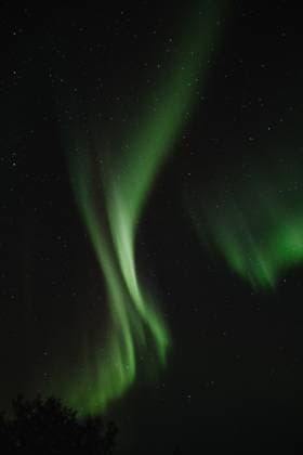 An ethereal display of the Northern Lights, or Aurora Borealis, arcs across the night sky in Iceland, creating a breathtaking natural spectacle. Model Released AlbertoOrtega_ID19187_570877_027 Copyright: xAlbertoxOrtegax