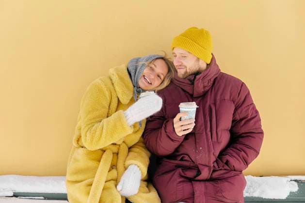 Happy couple enjoying coffee together in front of yellow wall model released, Symbolfoto, SANF00166