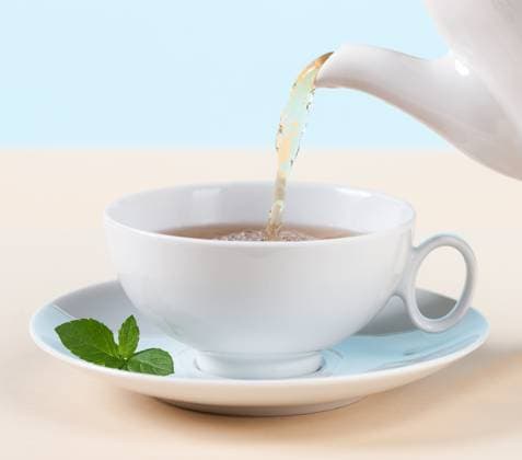 Pouring hot tea into white cup with mint Iceland, Kópavogur R_EZDKCL240228I-1345937-01 ,property released