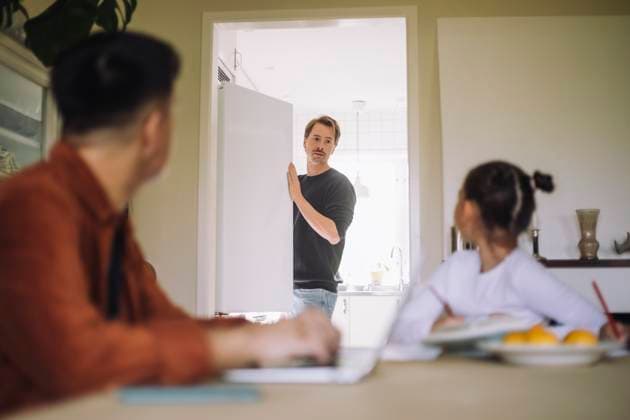 Daughter looking at father standing near refrigerator in kitchen at home Sweden, Stockholm, model released, property released Copyright: xMaskotx , MA107571 MA107571