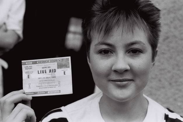 Female friend holds up her ticket to Live Aid, on the morning of the concert,198 Female friend holds up her ticket to Live Aid, on the morning of the concert,1985, Credit:Mark Charnock Avalon United Kingdom  Copyright: xMarkxCharnockx xAvalonx 0531870747