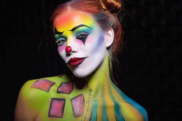 Nice young woman with a face painting clown. Nice young woman with a face painting clown posing in the studio on a black background ,model released, Symbolfoto Copyright: xZoonar.com SergeyxSukhorukovx 14142830 ,model released, Symbolfoto ,property released