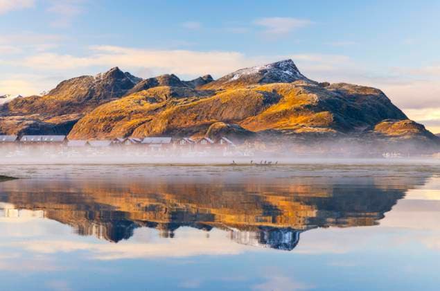 Mountains and rorbuer reflected in a Fjord during sunset, Leknes, Vestvagoy, Nordland, Lofoten Islands, Norway, Scandinavia, Europe Copyright: carloxalbertoxconti 1369-156