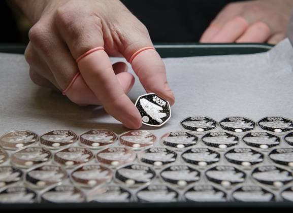 **VIDEO AVAILABLE: CONTACT INFO@COVERMG.COM TO RECEIVE** Star Wars™ Millennium Falcon landed on U.K. coins and bullion bars on Monday (18 March 2024). Following the success of its first Star Wars coin series, Britain™s Royal Mint has decided to strike back with a second series of coins with designs from the science-fiction franchise. Designed by Ffion Gwillim, the first coin is the series depicts the infamous Millennium Falcon, one of the most recognised and celebrated vehicles in the Star Wars galaxy. Collectors and fans will enjoy the coin™s unique lenticular feature, depicting a silhouette of the Millennium Falcon and the Rebel Alliance Starbird symbol. Combining traditional minting techniques with modern technology, The Roya Copyright: xx 53578934
