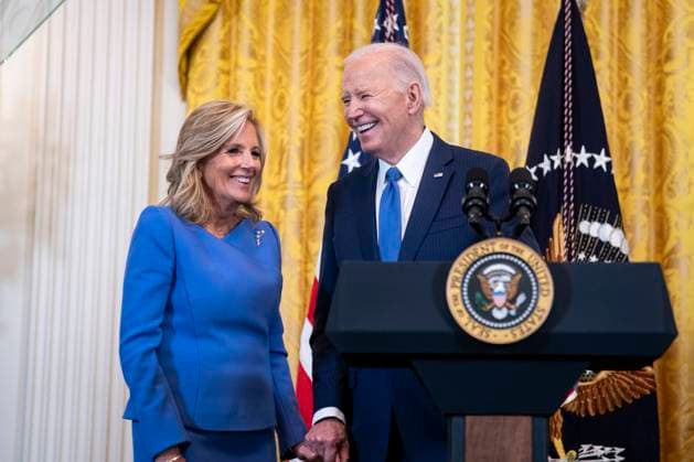 US President Joe Biden holds hands with US First Lady Jill Biden during a Women s History Month reception in the East Room of the White House in Washington, DC on Monday, March 18, 2024. The Biden administration is rolling out an executive order to strengthen women s health research standards across federal agencies and prioritize its funding in an effort to close the gap on long-standing disparities.  WAX20240318830 AlxDrago
